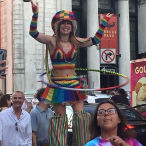 Lady Blaze rainbow stilt hooping pride parade